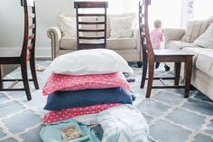 a pile of pillows sitting on top of a blue rug