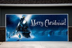 a large christmas sign on the side of a garage door in front of a brick building