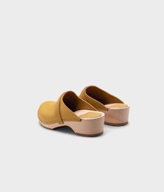 The best clogs for all occasions. Stylish with a nod to the past and an eye towards the future. With a handcrafted design, versatile colors, and comfortable wooden soles, these classic wooden clog mules will last you for years to come. Clog measurements:Heel height: 1 3/4” (4.5 cm)Toe height: 1 5/8″ (4.1 cm)Fit:RegularLeather:Nubuck leatherClogs consist of:Base: European Lime WoodSole: Rubber soleFastening: Staples Casual Wooden Clogs With Wooden Heel, Closed Toe Mules With Wooden Heel, Wooden Closed Toe Clogs With Wooden Heel, Casual Closed Toe Wooden Clogs, Casual Wood Closed Toe Clogs, Natural Closed Toe Mules With Wooden Heel, Wooden Slip-on Mules, Wooden Mules With Rubber Sole And Round Toe, Wooden Slip-on Clogs With Wooden Heel