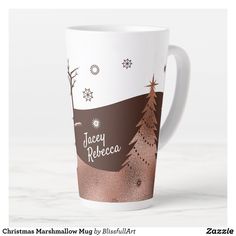 a white coffee mug with a christmas tree on the front and snowy trees in the back