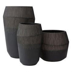 three black vases sitting next to each other