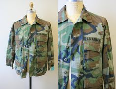 "Description: Vintage US Army camouflage jacket. Cotton. Long sleeves with a button front. It has four front pockets. Condition: In good condition, with no holes or stains. There is a chest patch missing (you can see where it was stitched on). Designer: n/a Stated Size: n/a Measurements: Armpit to armpit: 24\" Shoulder to shoulder: 19\" Sleeve length: 23\" Overall length: 29.5\" Waist: up to 54\" ---> If you need an order shipped by a particular date or shipped via a quicker method, please as Military Camouflage Outerwear With Buttons, Army Camouflage, Camouflage Jacket, Us Army, Military Jacket, Camouflage, Mens Jackets, Vintage Outfits, Overalls