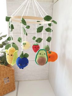 crocheted fruits and vegetables hanging from a mobile