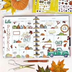 an open planner with fall leaves, pumpkins and other things to do on it