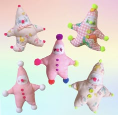 four stuffed toys are in the shape of stars