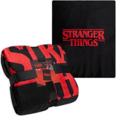 a black and red blanket with the words strange things on it