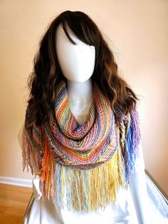 "Qilian Foothills Shawl" Named for the colorfully striped foothills in the Zhangye Danxia park in China, this is a perfect Spring/Summer/Fall layering accessory! Lightweight wool blend adds warmth while lacy sections, texture, and striping add visual interest.  Soft pastels, metallic highlights, and fringe evoke the Boho style. Makes a great gift for Mother's Day, Valentine's, birthdays, bridal shower, and proms. Size: 72" x 26", 7" fringe. Sized to fit most up to XL. Fiber Content: 51% Wool, 49% Acrylic Care Instructions: Hand-wash at 86℉ (30oC) / Do not tumble dry / Dry flat and block to shape. Like this style but want different fiber, color(s), or size? We love custom orders - see the last photo for other colors in this yarn! Please allow 3 weeks/piece for custom orders to ship. Multicolor Fringed Scarves One Size, Bohemian Multicolor Shawl One Size, Multicolor Yarn Shawl, Colorful Handmade Bohemian Shawl, Bohemian Multicolor Shawl, Multicolor Hippie Shawl One Size, Multicolor One-size Hippie Shawl, Multicolor Handwoven Shawl For Fall, Hippie Multicolor One-size Shawl