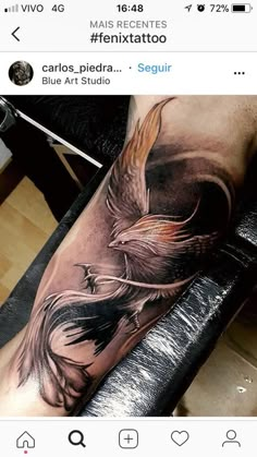 a person with a tattoo on their arm that has an image of a bird in it