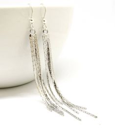 Beautiful bright silver 5 strand snake chain fringe earrings. The ear wires are sterling silver and the snake chain is bright shiny silver plate. The length is 3 1/4 inches from the top of the ear wire. Same earrings in Silver with 3 strands https://etsy.me/2yc46zq Same earrings in Rose Gold with 3 strands https://etsy.me/2sXEjWR Same earrings in Rose Gold with 5 strands https://etsy.me/2HSaBH8 Same earrings in Yellow Gold with 5 strands https://etsy.me/2LPnfZP All items come in a lovely gift bo Silver Earrings Long, Silver Tassel Earrings, Earrings Snake, Long Silver Earrings, Long Chain Earrings, Chain Fringe, Long Tassel Earrings, The Snake, Earrings Long