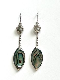 Faceted crystal quartz & abalone dangle earrings set in sterling silver. Hand made. Iridescent Oval Sterling Silver Jewelry, Iridescent Pierced Drop Earrings, Elegant Iridescent Jewelry For Pierced Ears, Elegant Pierced Jewelry In Mother Of Pearl, Elegant Mother Of Pearl Jewelry, Elegant Iridescent Drop Jewelry, Elegant Silver Abalone Shell Jewelry, Iridescent Mother Of Pearl Dangle Jewelry, Elegant Iridescent Mother Of Pearl Jewelry