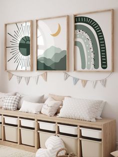 three framed pictures hang on the wall above a bench with storage bins underneath it