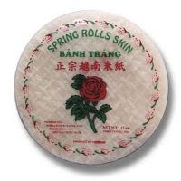 a round white plate with a red rose on the front and green leaves around it