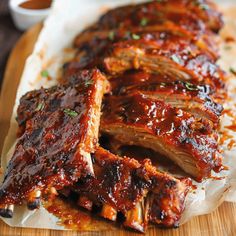 barbecue ribs with sauce and garnish on a cutting board