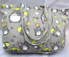 a gray totoro bag with yellow accents