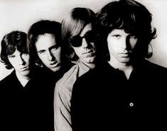 the rolling stones posing for a black and white photo in front of a white wall