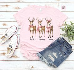 Get ready for the festive season with our adorable Christmas Family Shirts! 🎄👚 This charming pink crew neck features a delightful illustration of reindeer, each adorned with cute accessories, making it the perfect holiday pajama top. Whether you're lounging at home or posing for those nostalgic Christmas photos, our "Dasher, Prancer, Dancer" design brings joy and holiday spirit. Ideal for mom, women, or the whole family for matching sweatshirts. Embrace the retro pink Christmas vibe and give a personalized gift that's popular right now! Perfect for cozy family pajamas and coquette Christmas celebrations. Spread the festive cheer with this custom text sweater--an ultimate festive holiday gift! 🎅✨ Have questions? Send us a message, and we'll gladly help you. 🌟 🔗 YOU MAY ALSO LIKE: 🛍 Ch Pajamas Coquette, Dancer Design, Reindeer Names, Nostalgic Christmas, Coquette Christmas, Christmas Vibe, Matching Christmas Shirts, Family Presents, Accessories Making