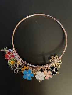 One adjustable handmade bracelet/bangle with floral charms / approx. 12 charms. CHARMS-rose gold/gold/silver flowers and clovers. Makes a great all-around gift, birthday gift, holiday gift or for self. Please visit my shop at https://www.etsy.com/shop/lilnjayproducts for more beautiful items. Adjustable Flower Bracelets With Lobster Clasp, Flower Charm Bracelet Jewelry For Friendship, Flower Charm Bracelet For Friendship, Metal Bracelets With Flower Shape For Gift, Friendship Flower Charm Bracelets, Metal Flower-shaped Bracelets As A Gift, Friendship Bracelet With Flower Charm, Bohemian Metal Flower Bracelets, Bohemian Flower Metal Bracelets