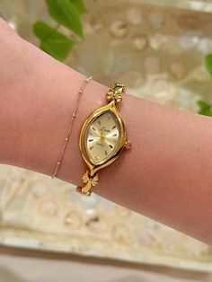 This gold tone vintage style quartz watch that has a unique watch face and dainty band. it's beautiful on and pair beautifully with other bracelets! - Length: 8 1/2 inches from one clasp to the other. - Works perfectly and has a new battery!  I suggest wiping it down with a soft cloth after each wear to ensure its longevity! Take a look at other beautiful watches here https://www.etsy.com/shop/vintagegirljewels?ref=seller-platform-mcnav As a small business, I'm unable to accept returns/refunds a Delicate Gold Watch Women, Vintage Watches Women Aesthetic, Vintage Dainty Watch, Dainty Watches, Dainty Gold Watch, Gold Watch Women, Unique Watches Women, Dainty Watch, Watch Minimalist