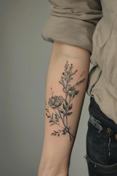 a woman with a flower tattoo on her arm