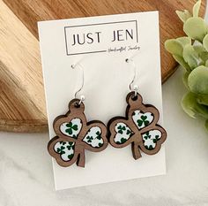 the earrings are made out of wood and decorated with shamrocks