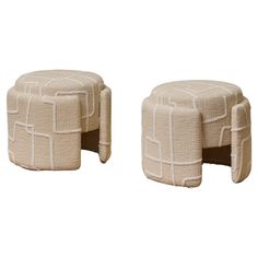 two small stools made out of fabric with white squares on the top and bottom