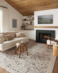 a living room filled with furniture and a fire place