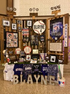 the table is covered with baseball memorabilia and signs that read, blvde