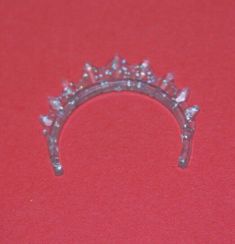 a tiara is sitting on a red surface