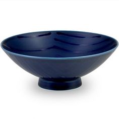 a blue bowl sitting on top of a white table