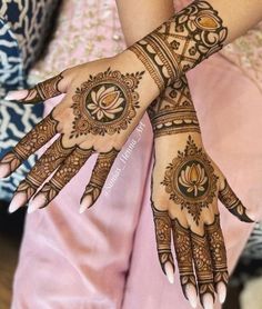 a woman's hands with hennap on it, showing the intricate design