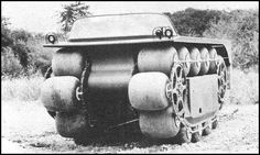 an old photo of a truck with wheels attached to it's rear end, in the middle of a field