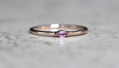 "A dainty marquise pink sapphire is at the center of our \"Wink\" ring, giving you just a little wink of sparkle! - Marquise stone measures 4mm x 2mm - Handcrafted out of 14K yellow, rose, or white gold - Round band measures 1.2mm in width Processing Times - Current processing time is 1 - 3 weeks. Each Item is handmade to order with love and care! In Stock Items - Contact Liesel Love with any rush order questions, or to see if we have anything ready made and in stock. Returns - Liesel Love does Pink Marquise Ruby Ring Fine Jewelry, Fine Jewelry Pink Marquise Ruby Ring, Pink Marquise Ring For Anniversary, Pink Marquise Promise Ring, Pink Marquise Gemstone Rings, Pink Marquise Gemstone Jewelry, Pink Marquise Jewelry For Anniversary, Pink Marquise Ring For Gift, Pink Marquise Rings For Gifts