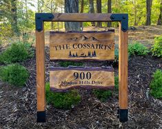 a sign for the coosair's wilderness sits in front of some trees