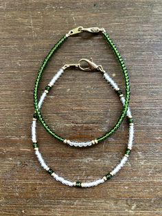 The beauty is in the simplicity in this line of my jewelry. Two dainty (but tough) bracelets are included- one with Jade accents, the other with a Clear Quartz center. Jade typically represents purity or purification and is regarded as a stone that protects loving energy, making it a symbol of gentleness and nourishment. It is also said to promote harmony and balance in the wearer. Clear Quartz is thought to be a universal healer, aiding in any and all areas that need a little love. Adjustable May Birthstone Jewelry For Meditation, Minimalist Green Beaded Bracelet For Everyday, Adjustable Minimalist Beaded Bracelets For May Birthstone, Green Bracelets With Tiny Beads For Everyday, Dainty Green Beaded Bracelets For Everyday, Minimalist Green Bracelet For Everyday Wear, Minimalist Green Jewelry For Everyday Wear, Green Everyday Bracelets With Tiny Beads, Elegant Stackable Meditation Jewelry