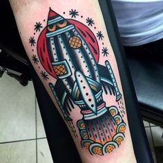 a man with a tattoo on his arm that has an image of a rocket ship