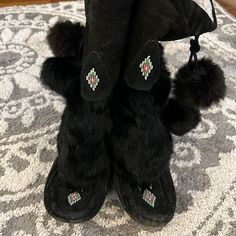 This Is A Pair Of Mukluk Boots. No Size Label; I Am A True Size 8 And These Are Slightly Small On Me So I Am Listing Them As A Size 7. Black Suede With Rabbit Fur Shaft And Pom Poms. Pom Poms Are On Outer Side Of Each Boot And Can Be Worn Tied In A Bow Or Hanging Down. Traditional Moccasin Beading. Please Note: Moderate To Heavy Wear To Soles, Toes And Heels. Some Dust On Suede From Storage. Wear And Marks On Suede Throughout; Larger Mark On Outer Side Of Right Boot Near Brand Tag As Shown. All Moccasin Beading, Mukluk Boots, Paris Hilton, Rabbit Fur, Brand Tags, Pom Poms, Boots Black, Canada Goose Jackets, Winter Boot