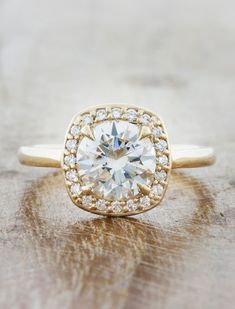 The Harlow is exquisite. She exhibits a forceful brilliance, but remains delicate and feminine at the same time. Her center stone is a source of light and love, while the diamond accents on the halo add an even more unbelievable sparkle to the design. Approx Band Width (mm): 1.70mm Setting Diamond Quality (side stones): Colorless and VS clarity Approx Setting Total Carat Weight (side stones): 0.099 tcw Approx Production Time: 5-6 weeks Drop-down diamond options represent our recommended grade, w Unique Engagement Rings Halo, Cushion Halo Engagement Ring, Pave Band, Plain Bands, Yellow Gold Setting, Green Sapphire, Halo Diamond Engagement Ring, Ring Fit, Sapphire Engagement