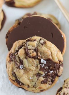 a chocolate chip cookie and some cookies on a table