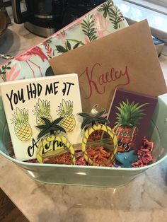 a bowl filled with cards and pineapples on top of a counter