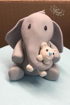 an elephant and its baby sitting on top of a cake