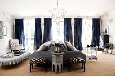 a living room filled with furniture and a chandelier