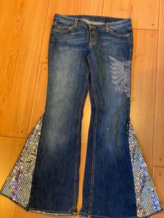 I use completely Up-cycled materials in creating these one of a kind Bell Bottom style jeans. These Chic Refashioned Bell Bottoms have the perfect flare and are perfect for a day at the office or dress them up for a night out of town.  Size 11 women's jeans They have a lovely flow to them and are unlike any other Bell Bottoms out there, you certainly will sparkle and shine. The outside flare is a beautiful silver sequence which coordinates lovely with the embellishment on the left upper thigh. P Straight Leg Denim Sequined Bottoms, Sequined Straight Leg Denim Bottoms, Straight Leg Denim Bottoms With Sequins, Straight Leg Sequin Denim Jeans, Sequined Straight Leg Denim Jeans, Straight Leg Denim Jeans With Sequins, Fitted Cotton Jeans For Party, Heart Shaped Rocks, Jeans Style