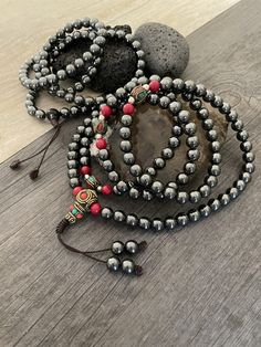 Unique Protection Mala necklace, made with Hematite stone beads. A necklace that will keep you in style and grounded at the same time, as you can use this 108 mala necklace for metidating. A perfect gift for your love ones. You can choose between the mala that has Hematite and a mix of red beads, or the one that is just Hematite all around. The just stone Mala is 40.6cm- 16 inch long The stone and red Mala is 27cm- 18.5 inch long A most have addition to your jewelry collection. ⚡️Join Akashi's V Spiritual Polished Round Bead Jewelry, Spiritual Polished Round Beads Jewelry, Spiritual Style Polished Round Beads Jewelry, Spiritual Colorful Beaded Necklaces, Adjustable Beaded Crystal Necklaces With Oval Beads, Bohemian Necklaces With 8mm Beads, Bohemian Necklace With 8mm Round Beads, Spiritual Crystal Necklaces With Colorful Round Beads, Adjustable Beaded Crystal Necklace With Oval Beads