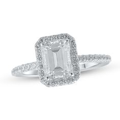 an emerald cut diamond ring with pave set shoulders