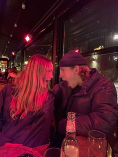 two people sitting at a table in a restaurant