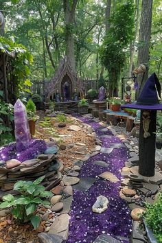 a garden filled with lots of purple rocks and plants on top of it's sides