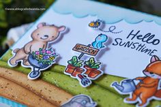 a close up of a hello sunshine card with flowers and animals on it's side