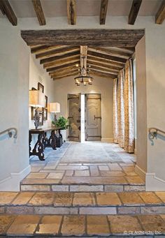 the inside of a house with wood floors and white walls