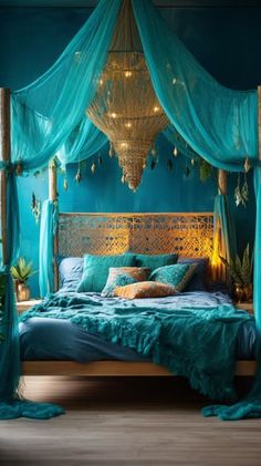 a bed with blue sheets and lights hanging from it's headboard in a bedroom