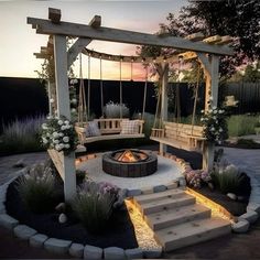 an outdoor fire pit with swings and seating